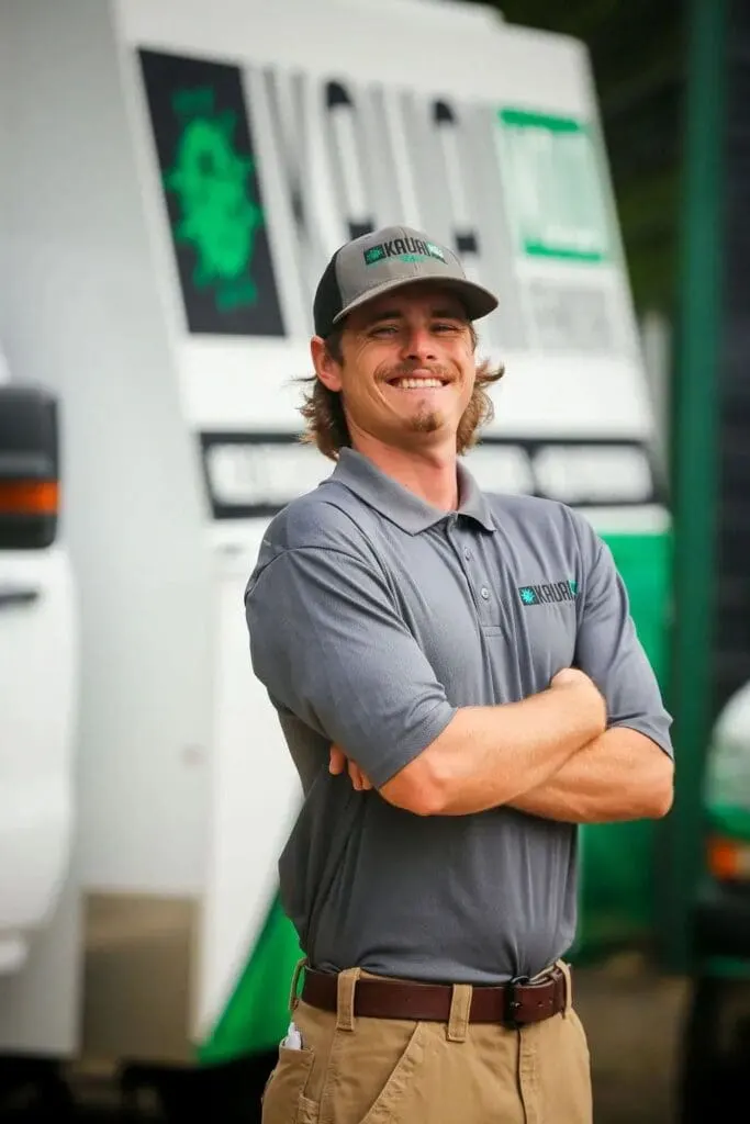 Tanner Diehl, Kauai regional restoration manager, standing in front of a company response van